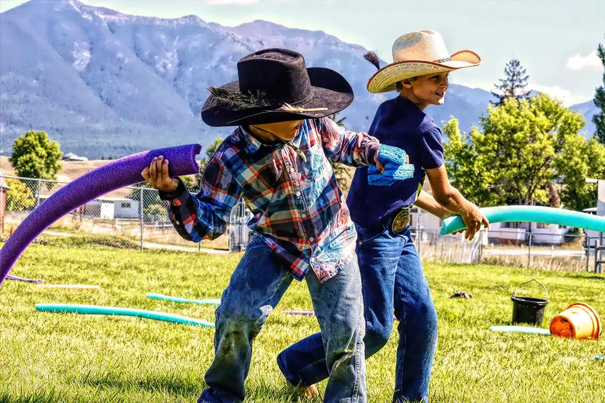 two boys having a noodle fight at the lincoln county fair